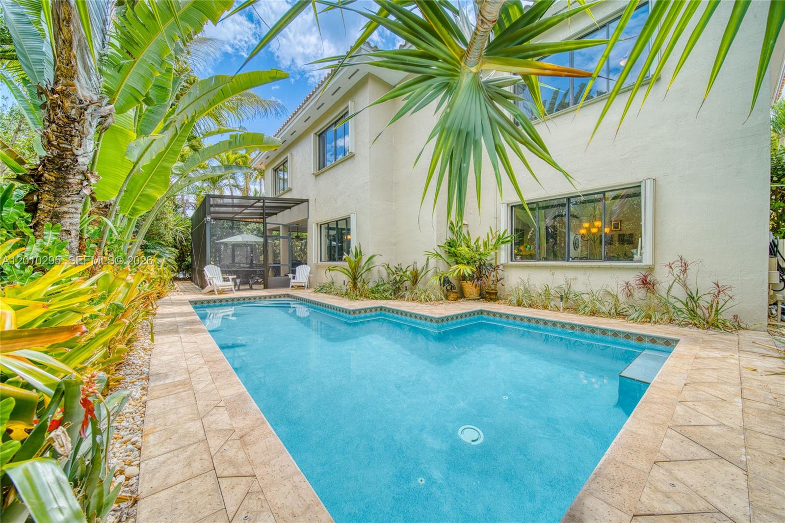A two-story house exterior features a swimming pool, a screened patio, and lush landscaping — 7601 SW 187th St, Cutler Bay FL 33157, CUTLER BAY, FL