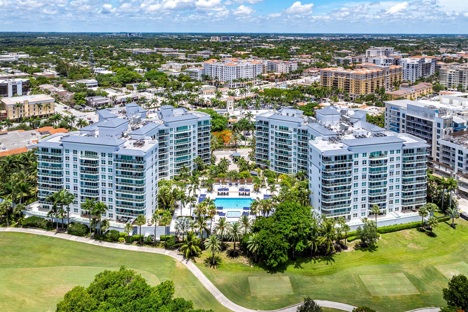 An aerial view shows a large residential complex with a central pool and golf course — 550 SE Mizner Boulevard # B110, Boca Raton FL 33432, BOCA RATON, FL