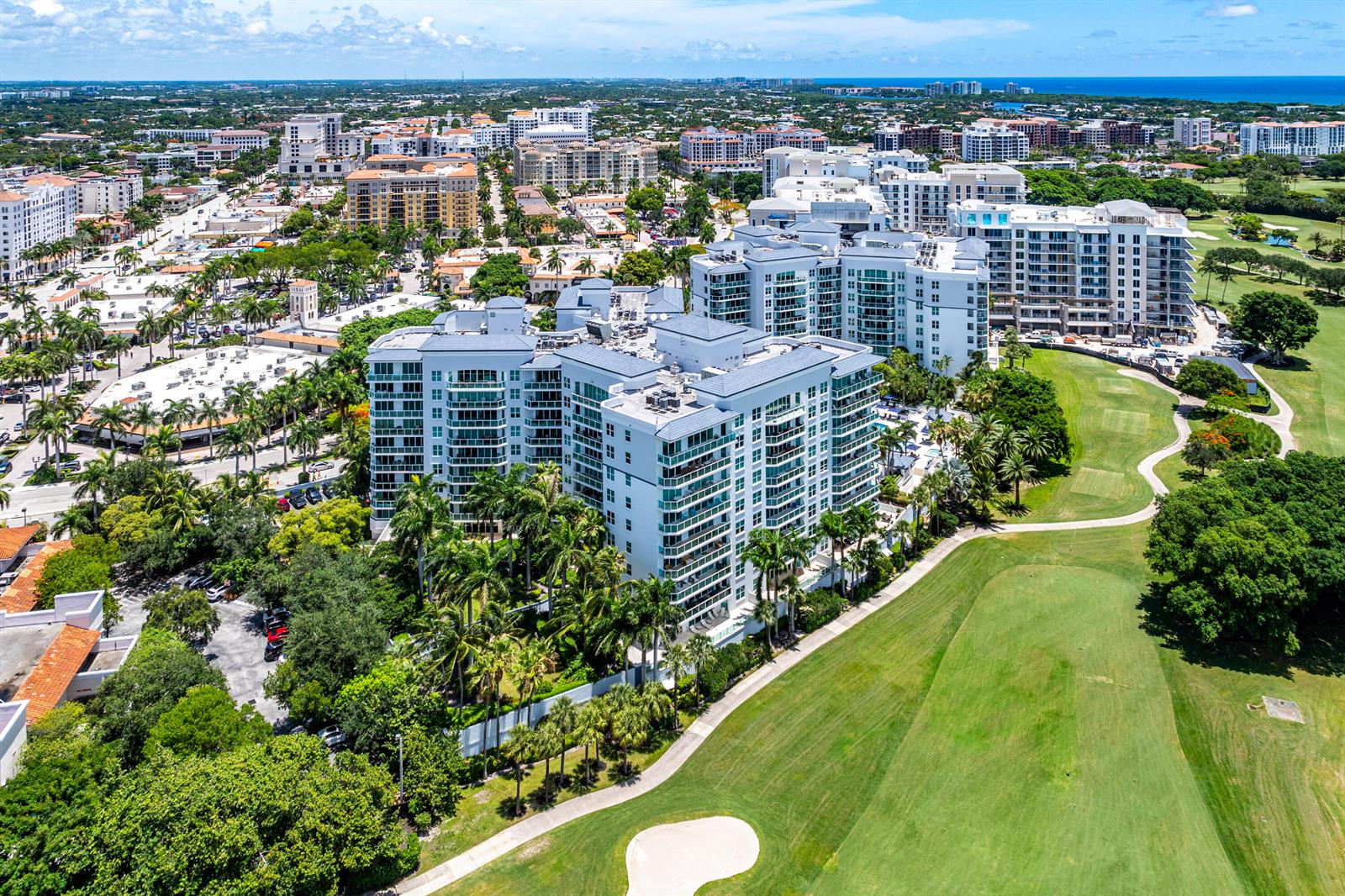 An aerial view of a multi-story apartment complex adjacent to a golf course — 550 SE Mizner Boulevard # B110, Boca Raton FL 33432, BOCA RATON, FL