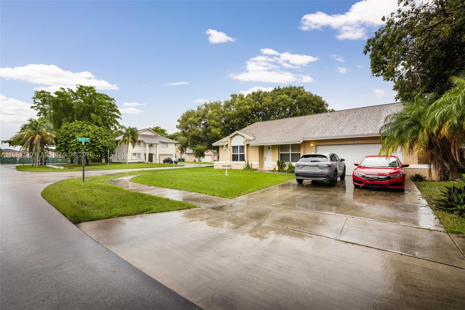 A single-story house with a two-car garage and two parked cars in the driveway — 9730 SW 219th St, Cutler Bay FL 33190, CUTLER BAY, FL