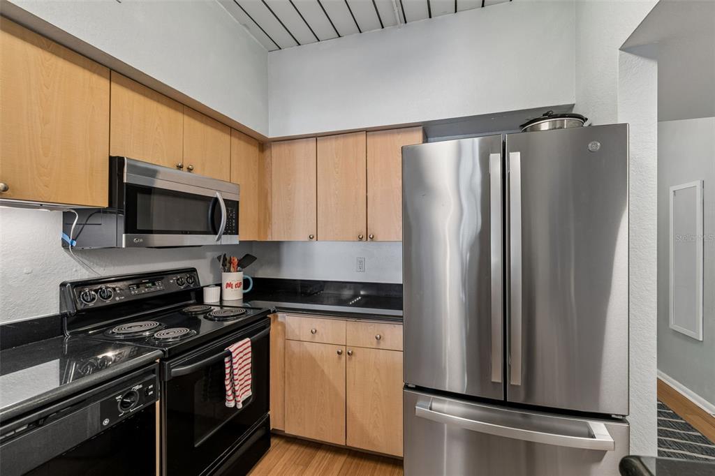 A bathroom features a light wood vanity, black countertop, white ruffled shower curtain, and tiled floor — 2331 W HORATIO STREET UNIT 625, TAMPA, FL