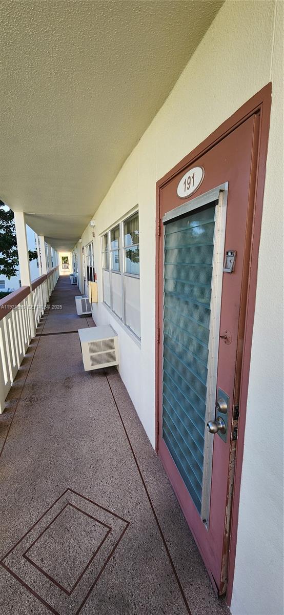 An exterior walkway leads past a door numbered 191 with a louvered glass insert — 191 E Preston  E # 191, Boca Raton FL 33434, BOCA RATON, FL