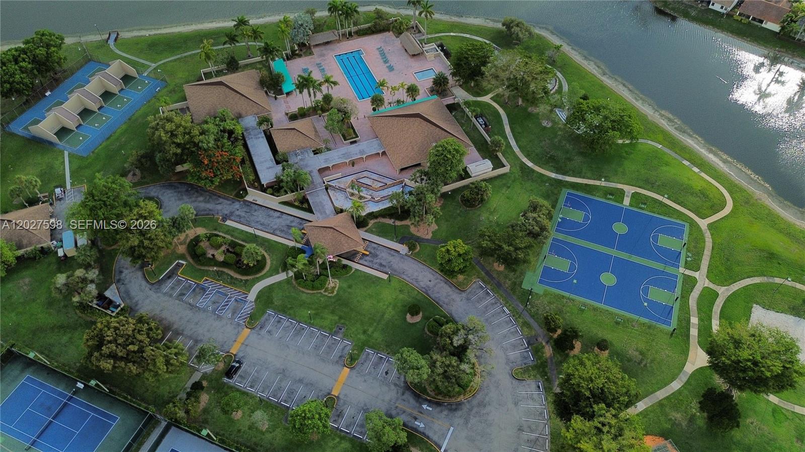 Aerial view of a community recreation center featuring a pool, tennis courts, and basketball courts — 14950 SW 49th Ln # 7C, Miami FL 33185, MIAMI, FL