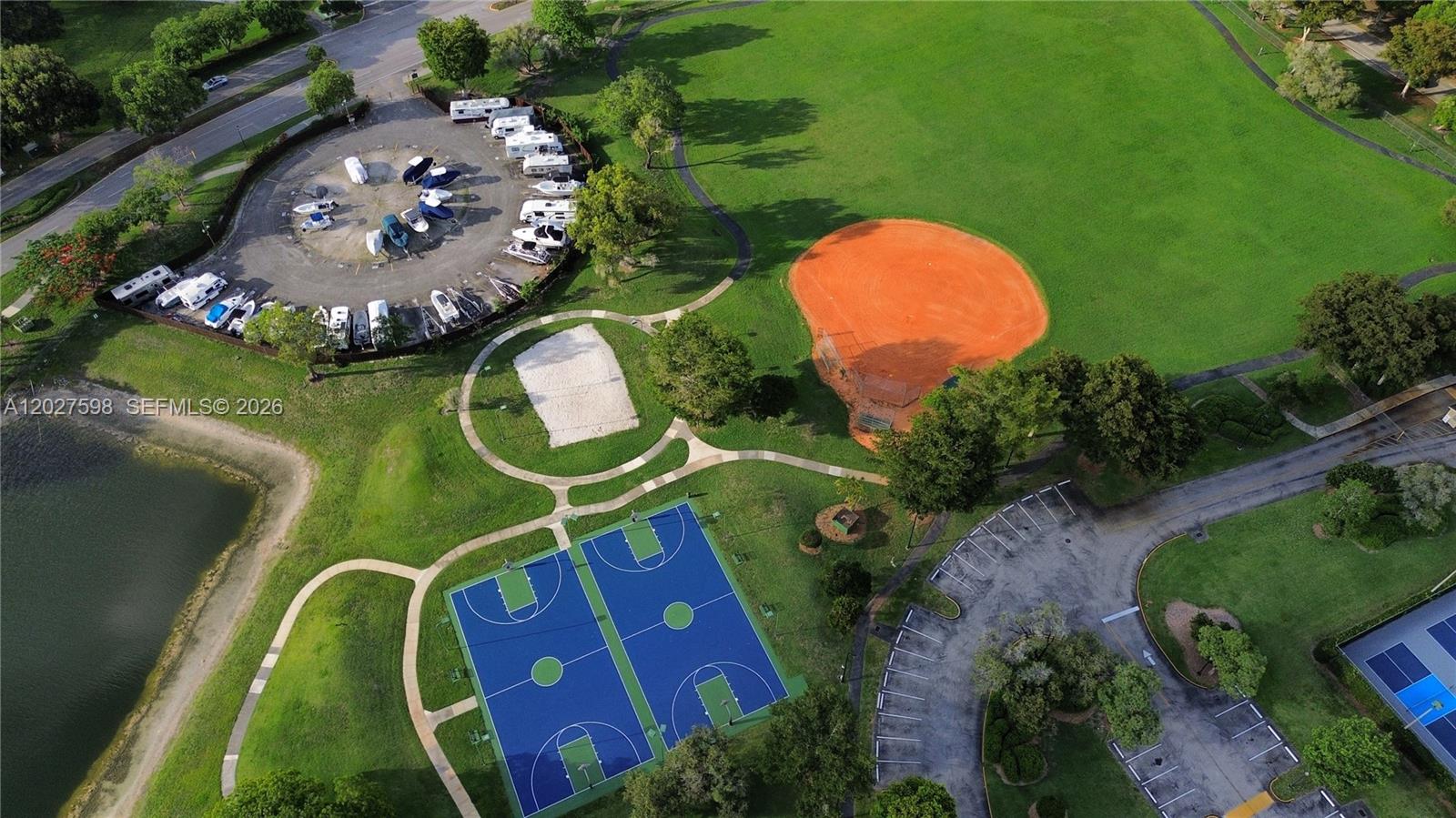 An aerial view shows a park with basketball courts, a baseball field, and boat storage — 14950 SW 49th Ln # 7C, Miami FL 33185, MIAMI, FL