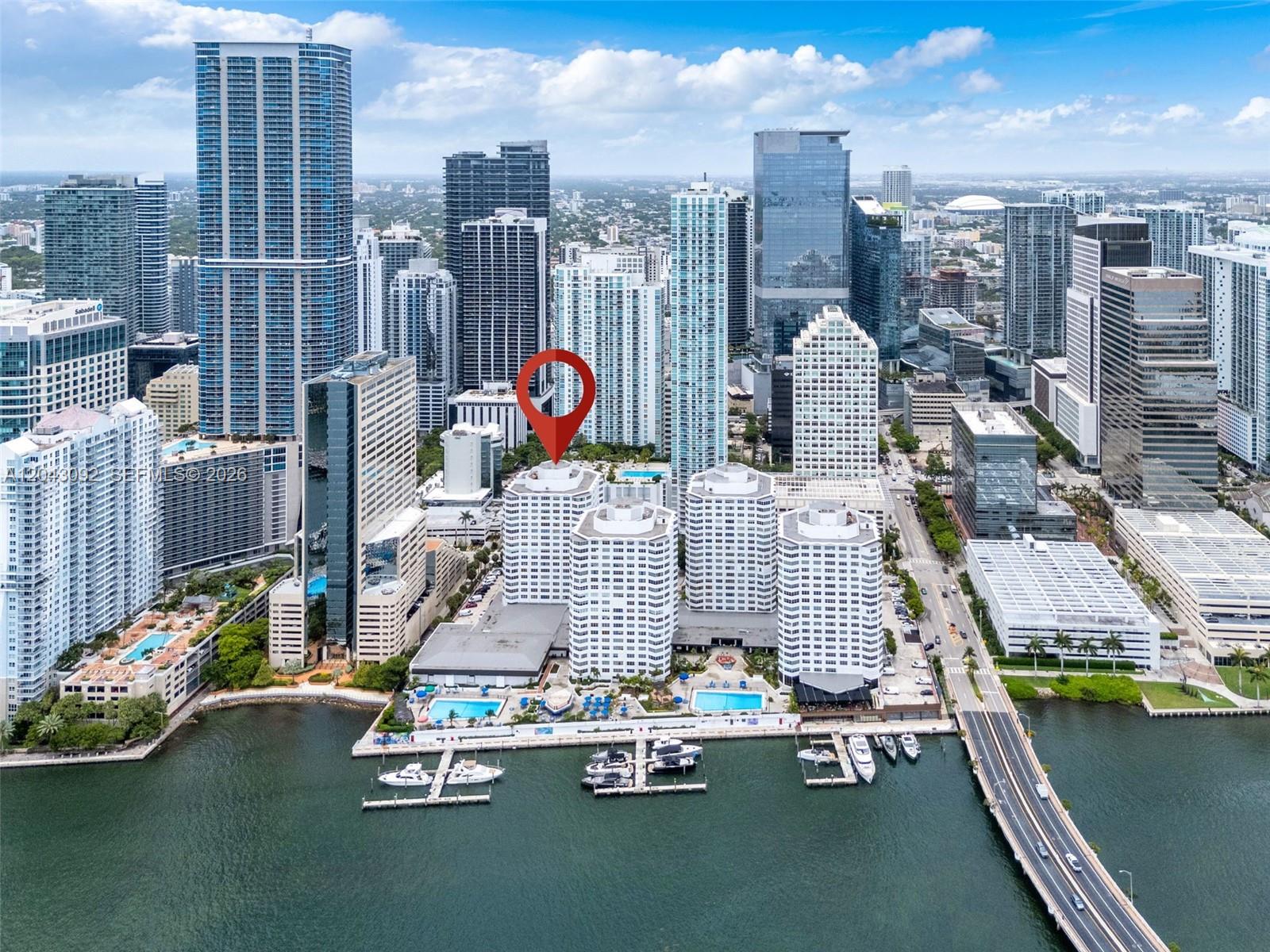 An aerial view shows a waterfront residential complex with a marina and city skyline — 801 Brickell Bay Dr # 669, Miami FL 33131, MIAMI, FL