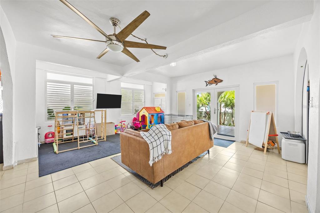 A living room features tile floors, a brown sofa, a ceiling fan, and children's play equipment — KENNEDY  ST. BO. MAMEYAL , , PR 006 LOT 106, DORADO, PR