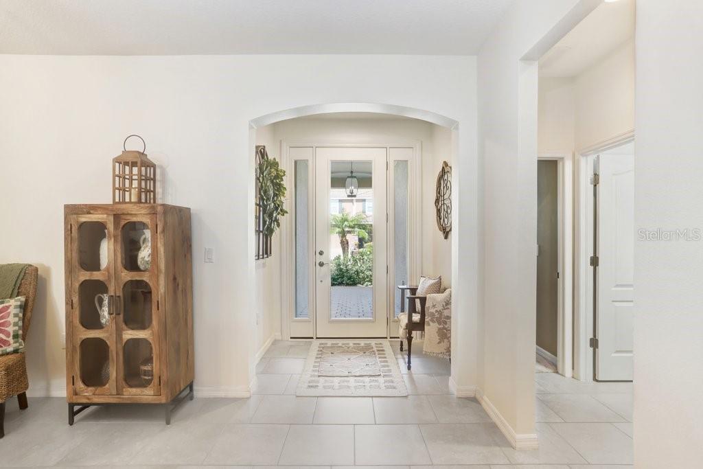 A screened-in patio features a rectangular swimming pool, brick pavers, and outdoor furniture — 2807 ORIOLE DRIVE, SARASOTA, FL