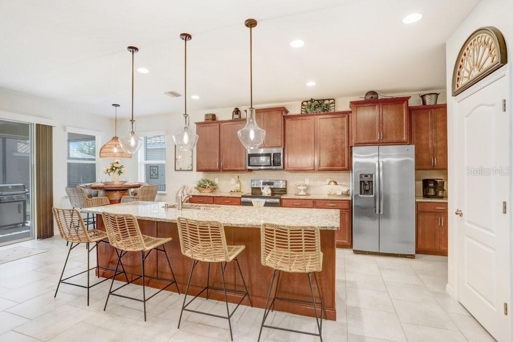 An entryway features a glass-paneled front door, light tile flooring, and a wooden cabinet — 2807 ORIOLE DRIVE, SARASOTA, FL