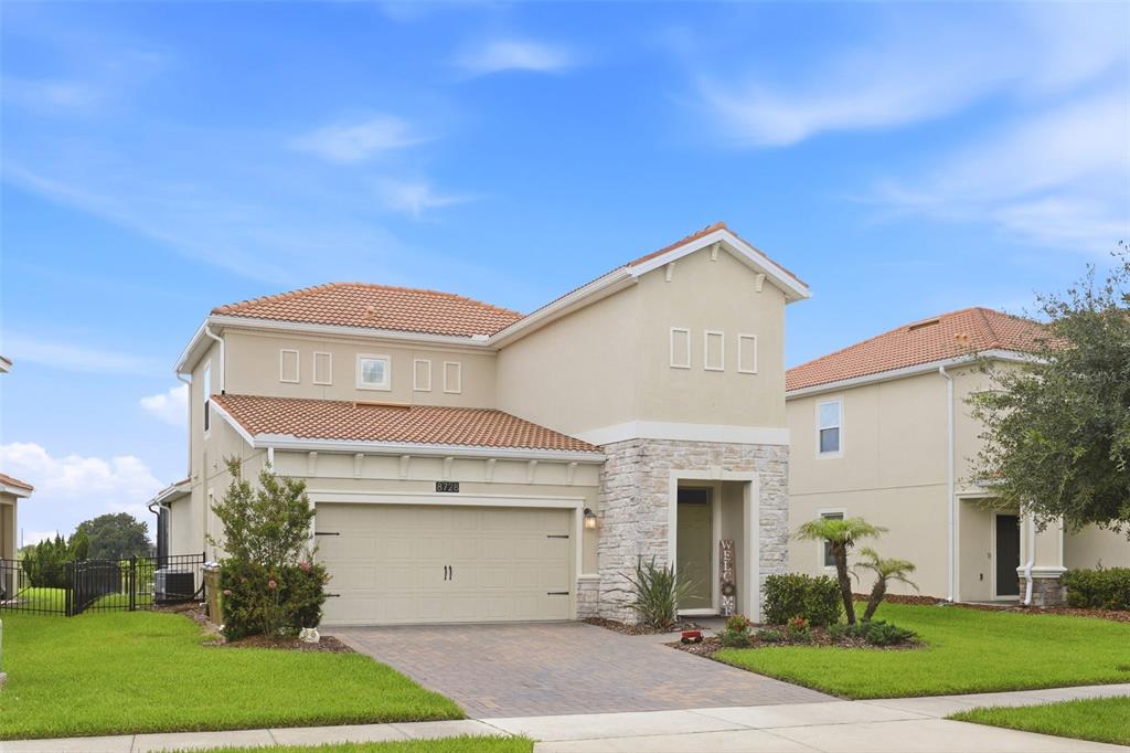 A living room with a gray sectional sofa, a shag rug, and an open kitchen — 8728 PACIFIC DUNES DRIVE, DAVENPORT, FL