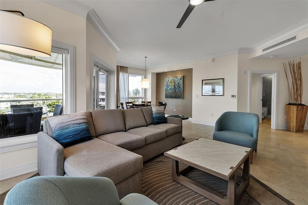 A living room features a sectional sofa, two armchairs, a coffee table, and a balcony — 915 SEASIDE DRIVE UNIT 410, Weeks 4-7, SARASOTA, FL
