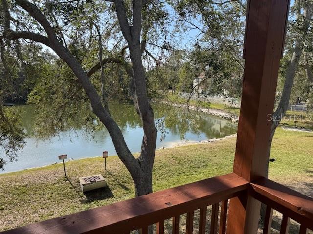 A view of a pond and trees from a wooden balcony — 6740 MOONGLOW DRIVE UNIT 201, PORT RICHEY, FL