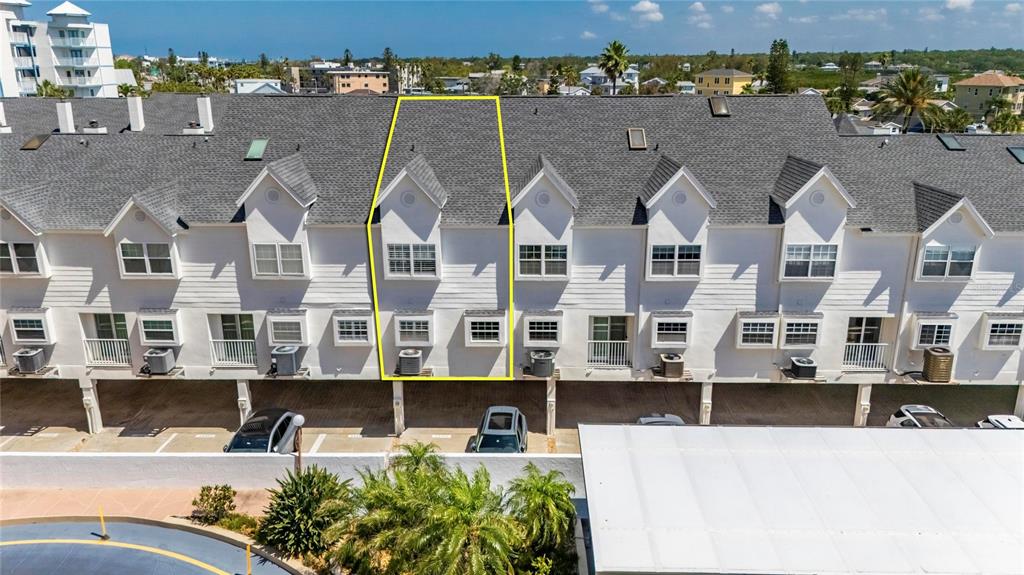 An aerial view shows a row of white townhomes with a highlighted unit — 17960 GULF BLVD UNIT 108, REDINGTON SHORES, FL