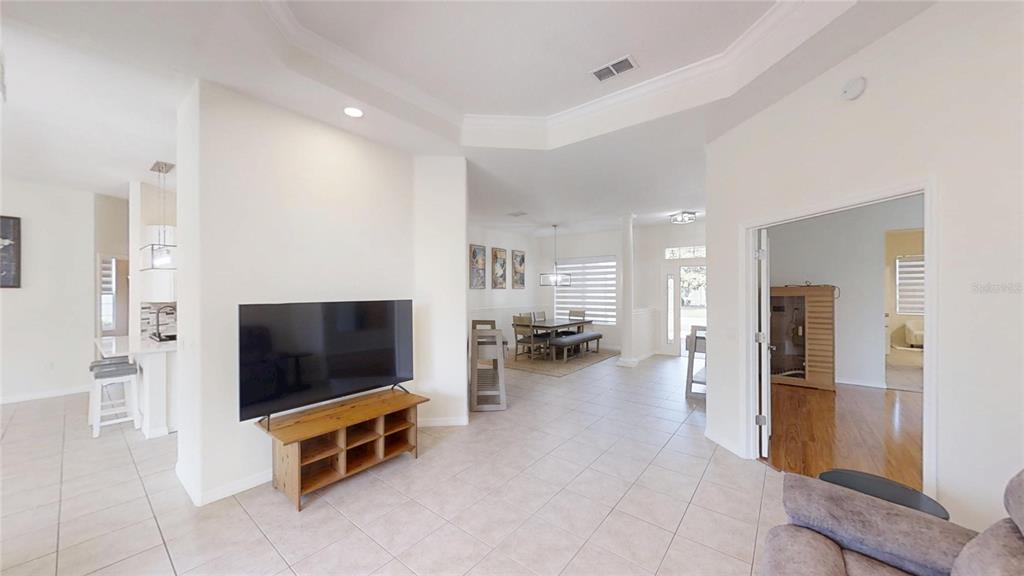 A living room with a television, dining area, and a room with a sauna — 8328 SW 84TH PLACE ROAD, OCALA, FL