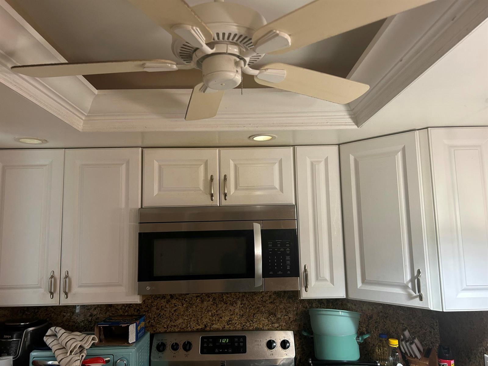 A kitchen features white cabinets, a stainless steel microwave, and a ceiling fan — 2214 NE 1st Way # 106, Boynton Beach FL 33435, BOYNTON BEACH, FL