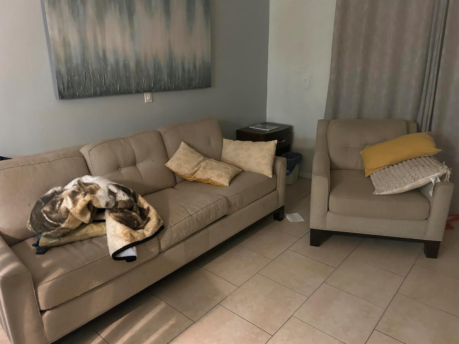 A living room features a beige sofa and armchair on a tiled floor — 2214 NE 1st Way # 106, Boynton Beach FL 33435, BOYNTON BEACH, FL