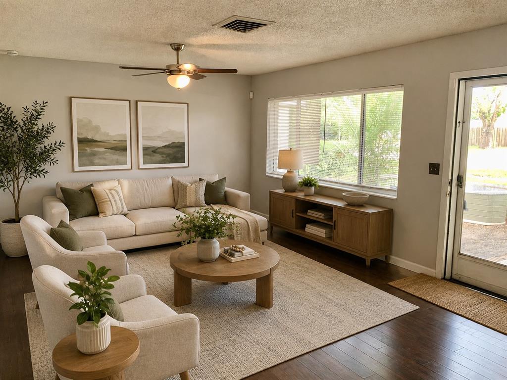 A living room features a beige sofa, two armchairs, a round coffee table, and wood flooring — 5050 29TH AVENUE N, ST PETERSBURG, FL