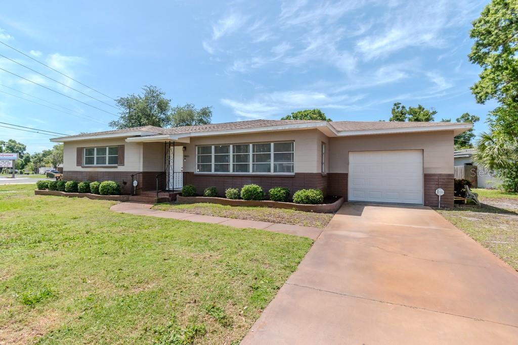 A single-story house with a brown and beige exterior, a front lawn, and a driveway — 5800 21ST AVENUE S, GULFPORT, FL