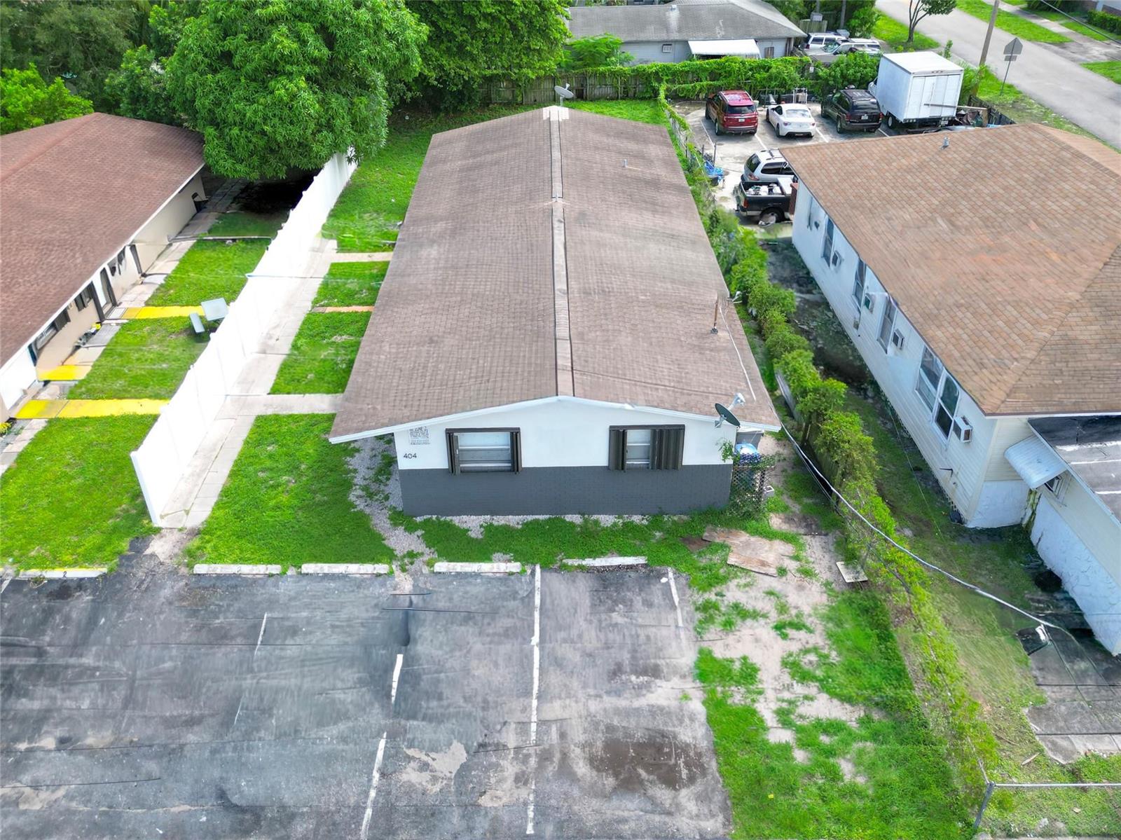 An aerial view shows a single-story building with a brown roof and a parking lot — 404 NE 4th Street, Pompano Beach FL 33060, POMPANO BEACH, FL