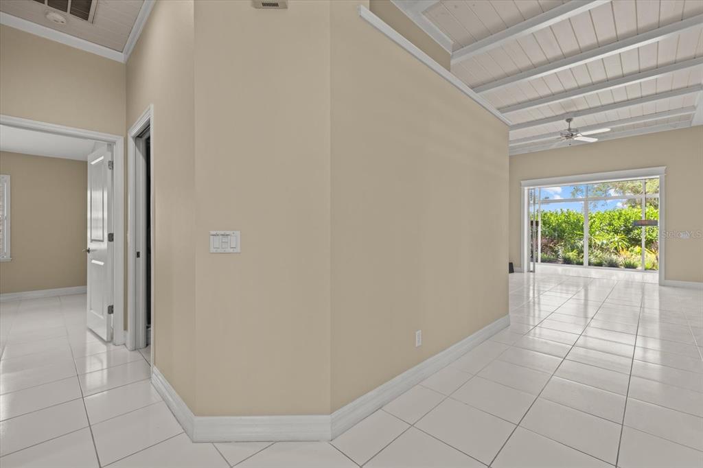 A bright room with white tile floors, a vaulted ceiling, and a large window view — 4444 DEER TRAIL BOULEVARD, SARASOTA, FL