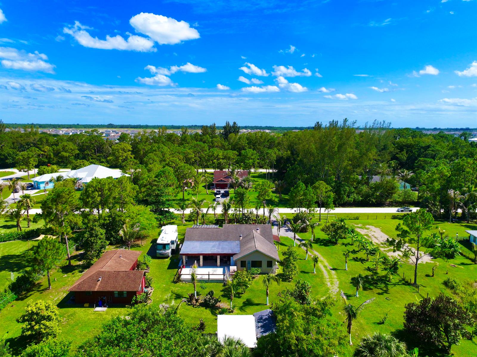 An aerial view shows a residential property with a house, detached building, and RV — 14539 N 60th Ct Court N, FL 33470, FL
