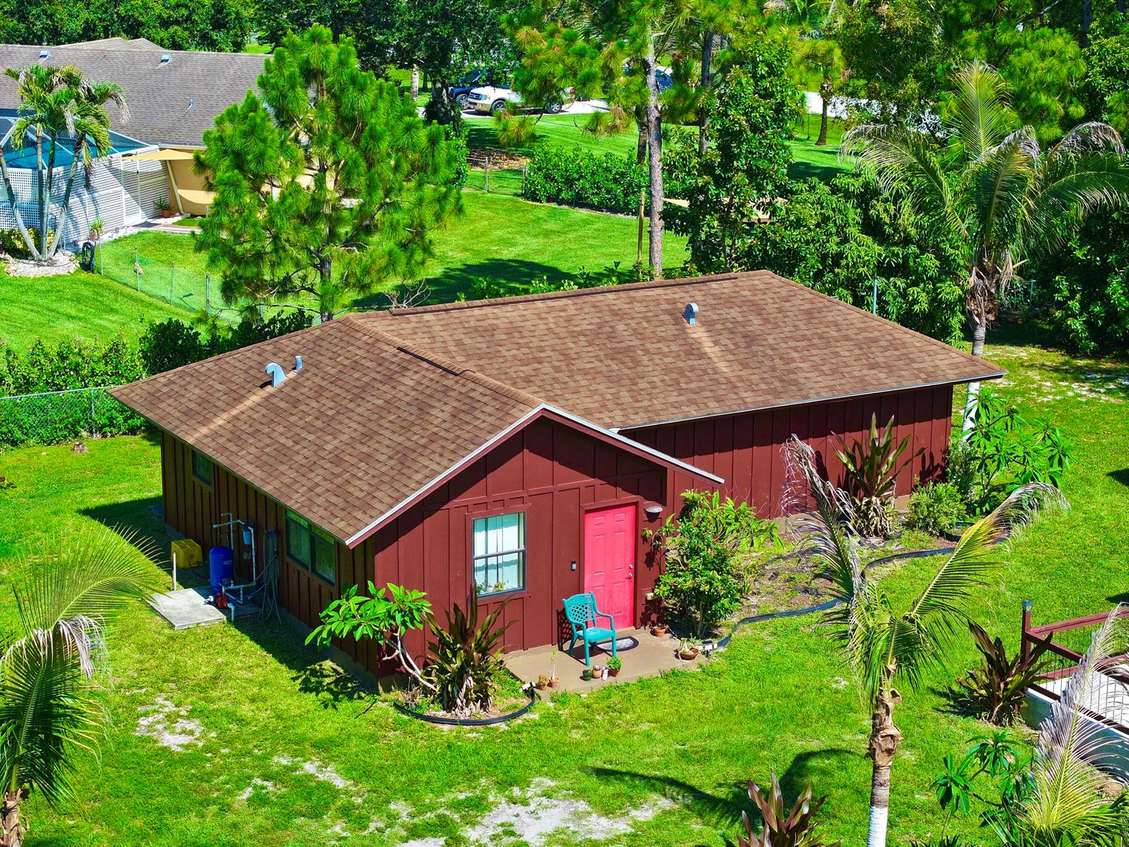 An aerial view of a brown house with a red door and a shingled roof — 14539 N 60th Ct Court N, FL 33470, FL