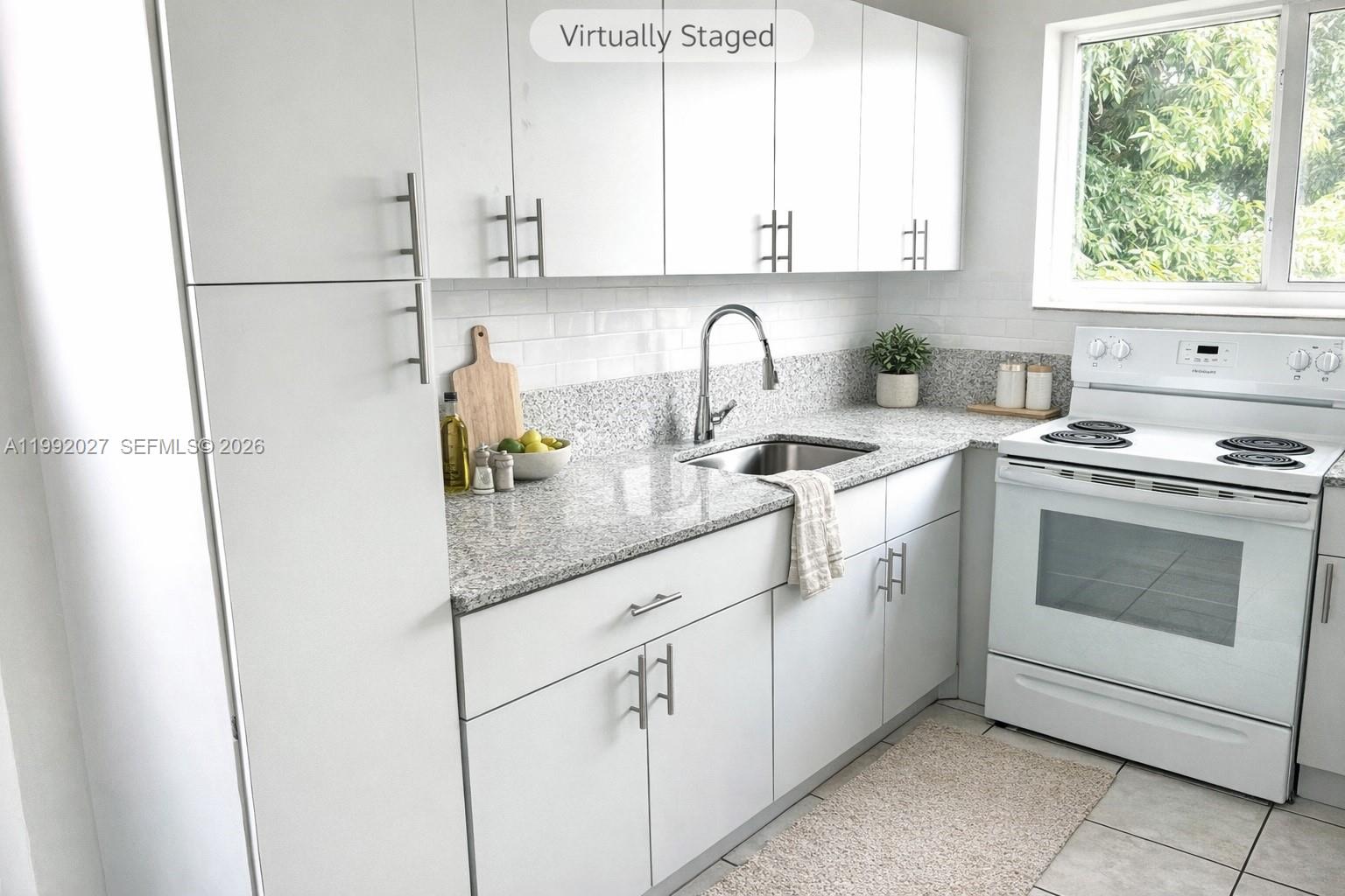 A kitchen features white cabinets, granite countertops, a stainless steel sink, and a white stove — 2121 SW 4th St # 2, Miami FL 33135, MIAMI, FL