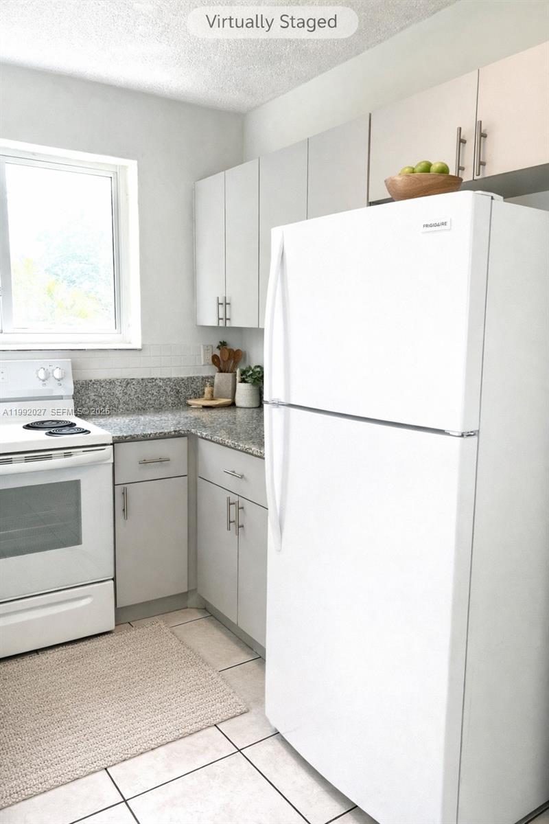 A kitchen features light gray cabinets, granite countertops, a white stove, and a white refrigerator — 2121 SW 4th St # 2, Miami FL 33135, MIAMI, FL