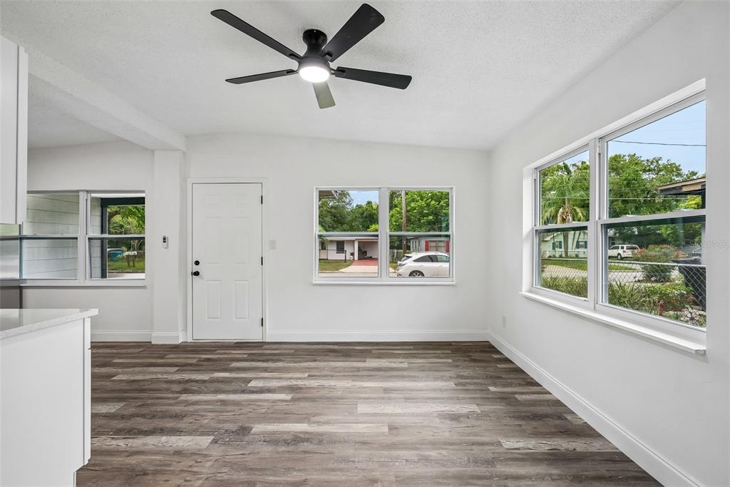 A white, single-story house with a black roof, dark trim, and a concrete driveway — 806 CITRUS STREET, ORLANDO, FL