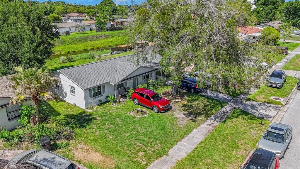 An aerial view shows a single-story house with a red SUV parked in the front yard — 4725 CEPEDA STREET, ORLANDO, FL
