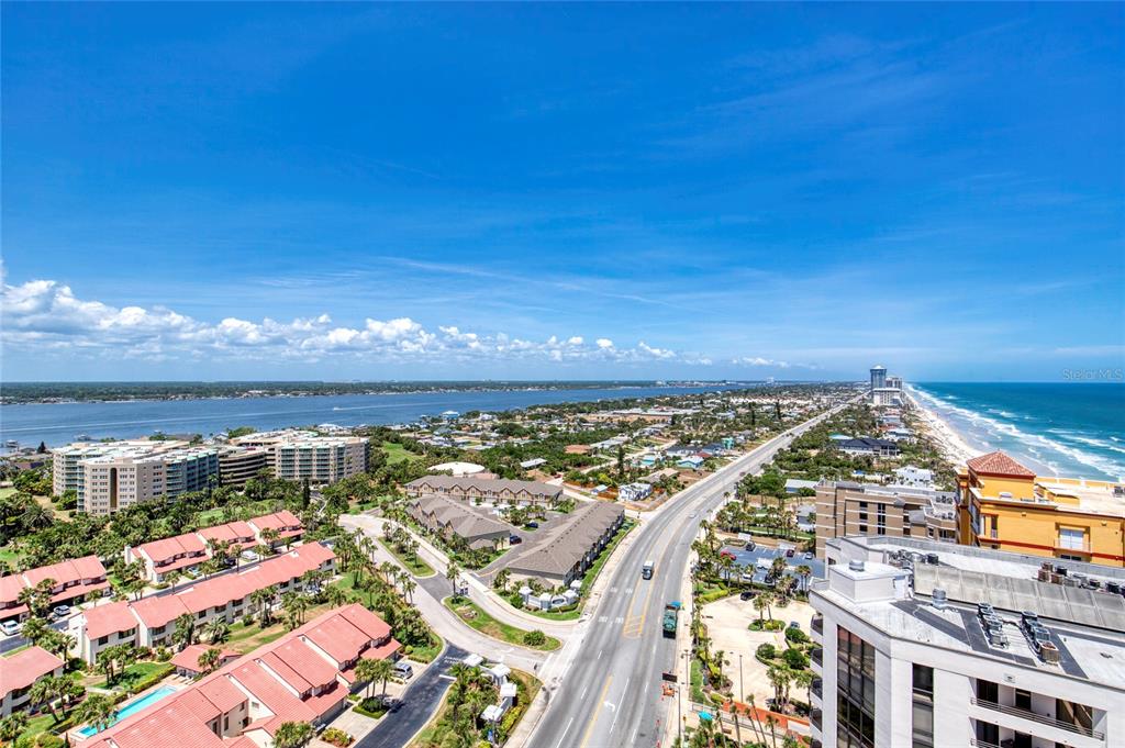 An aerial view shows a coastal road separating a residential area from the ocean — 2937 S ATLANTIC AVENUE UNIT 2001, DAYTONA BEACH, FL