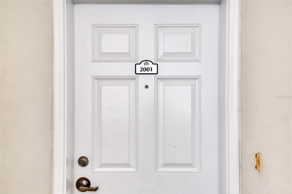 A white front door with four panels and the number 2001 displayed above the peephole — 2937 S ATLANTIC AVENUE UNIT 2001, DAYTONA BEACH, FL