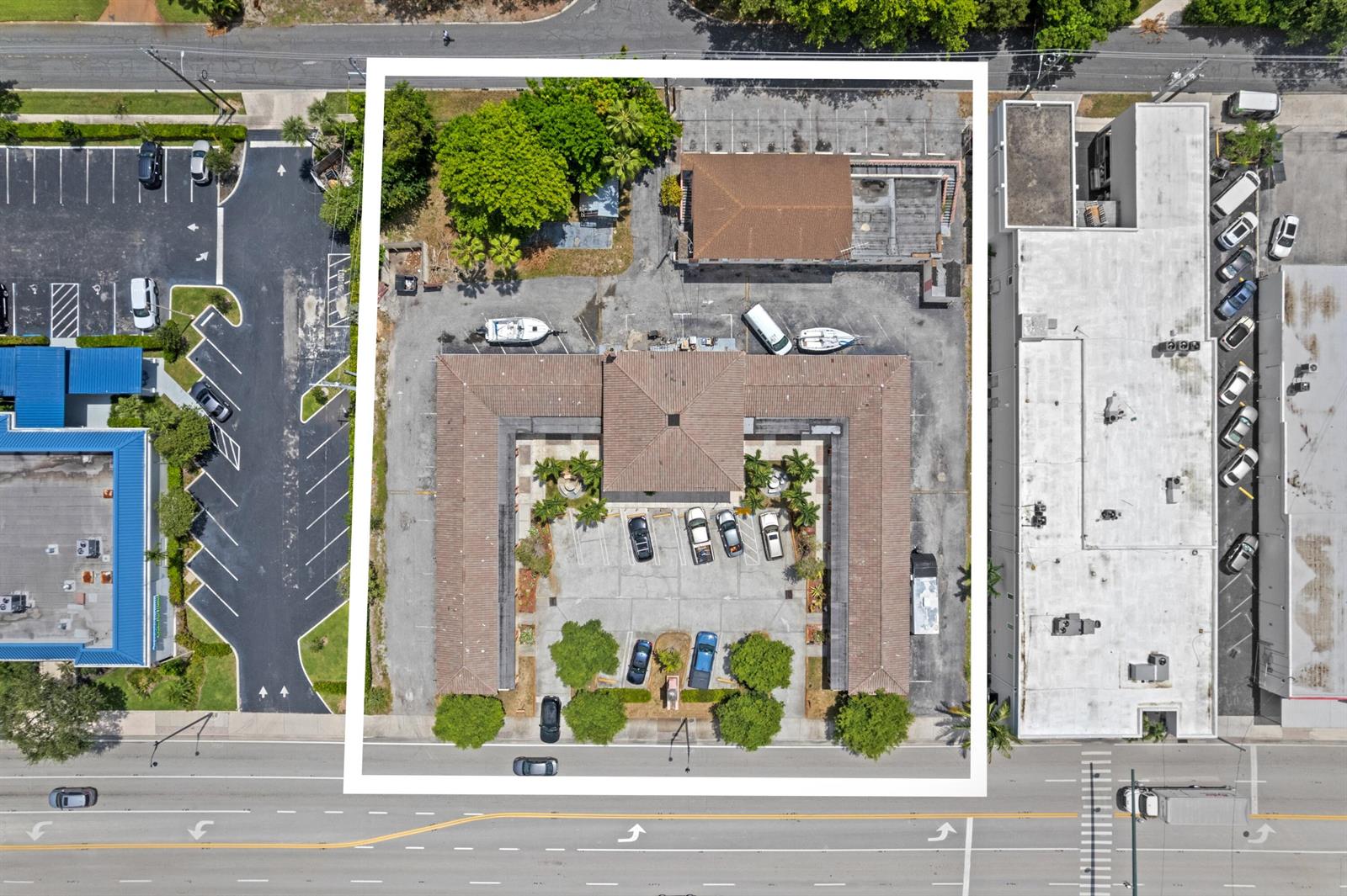 This aerial view shows a U-shaped commercial building with a central parking lot — 7800 S Dixie Highway, West Palm Beach FL 33405, WEST PALM BEACH, FL