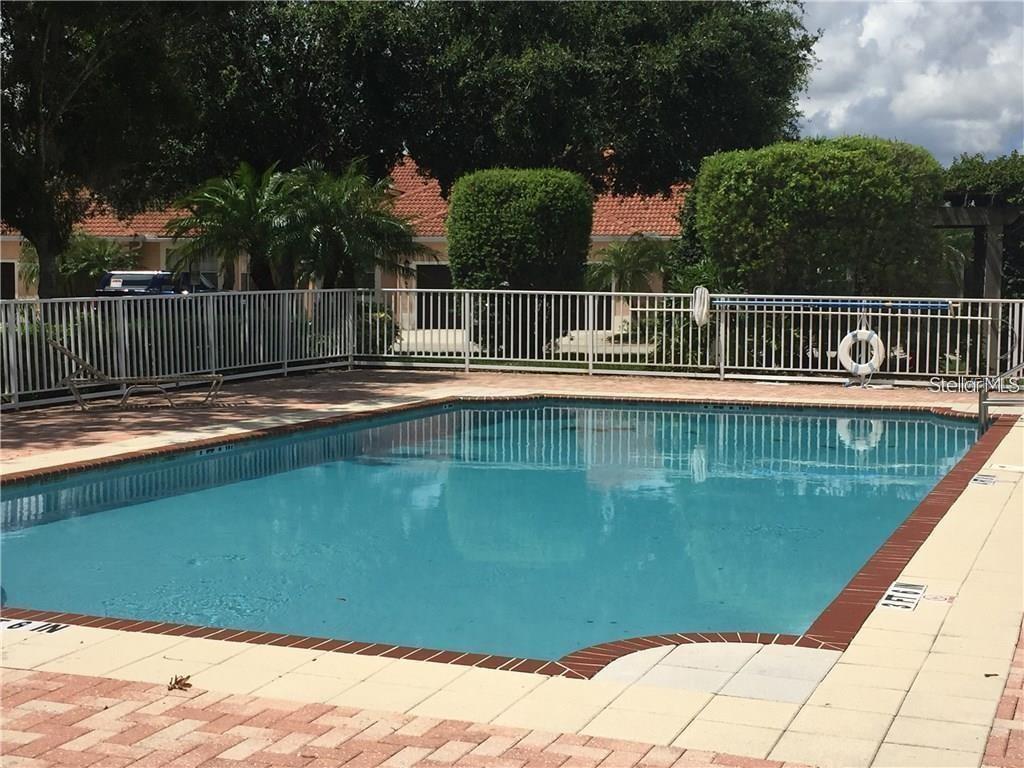 A rectangular swimming pool is surrounded by a white fence and a paved deck — 9035 VISTA VERDE DRIVE, PALMETTO, FL