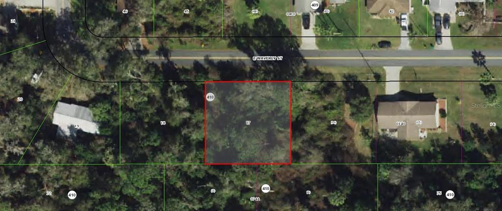 This is an aerial map view showing a rectangular, wooded vacant lot outlined in red — 5986 E WAVERLY STREET, INVERNESS, FL