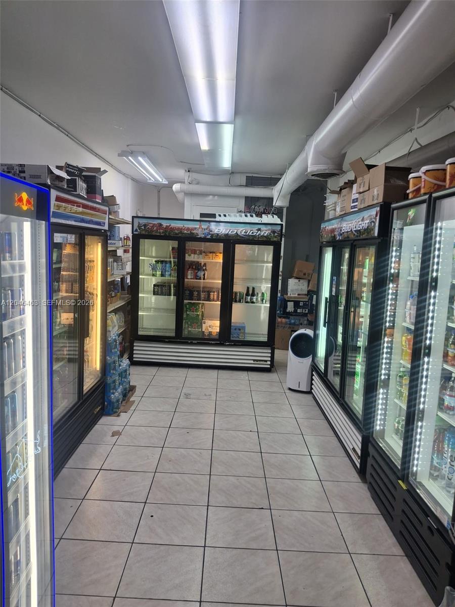 A commercial space features multiple glass-door beverage refrigerators and tiled flooring — Washington Ave, Miami Beach FL 33139, MIAMI BEACH, FL