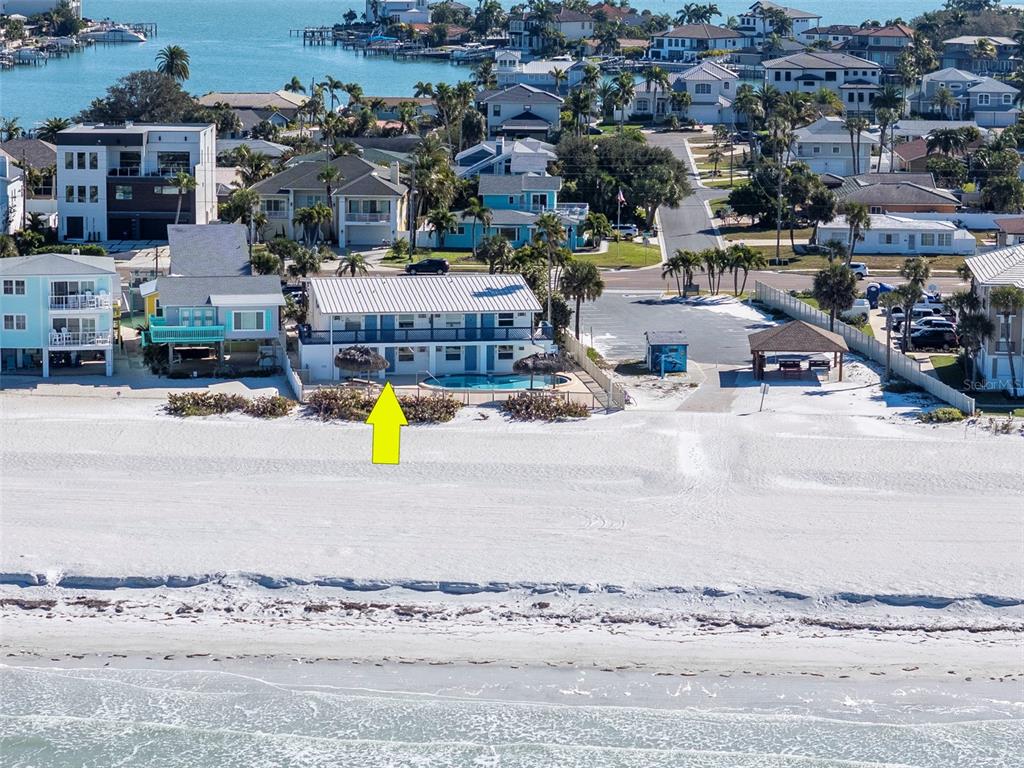 A white dining table sits before a large window overlooking a beach and ocean — 2700 GULF BOULEVARD UNIT 2W, BELLEAIR BEACH, FL
