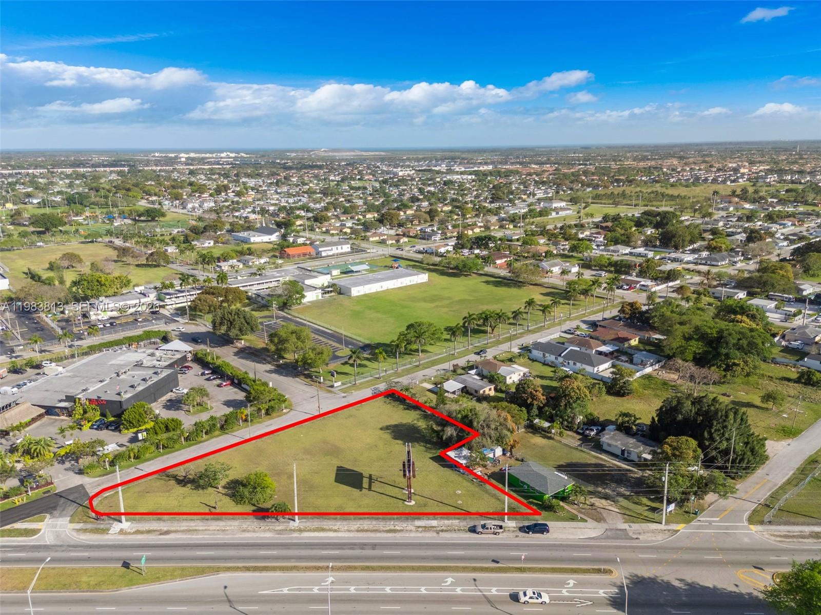 An aerial view shows a triangular vacant lot outlined in red next to a road — 21710 SW 118th Ave, Miami FL 33170, MIAMI, FL