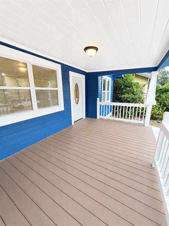 A blue-painted bungalow features a covered front porch, white trim, and a matching blue walkway — 1200 E HENRY AVENUE, TAMPA, FL