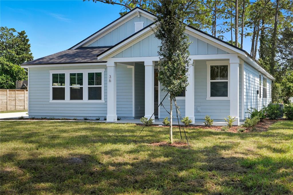 A light blue single-story house with white trim and a covered front porch — 36 BROCKTON LANE, PALM COAST, FL
