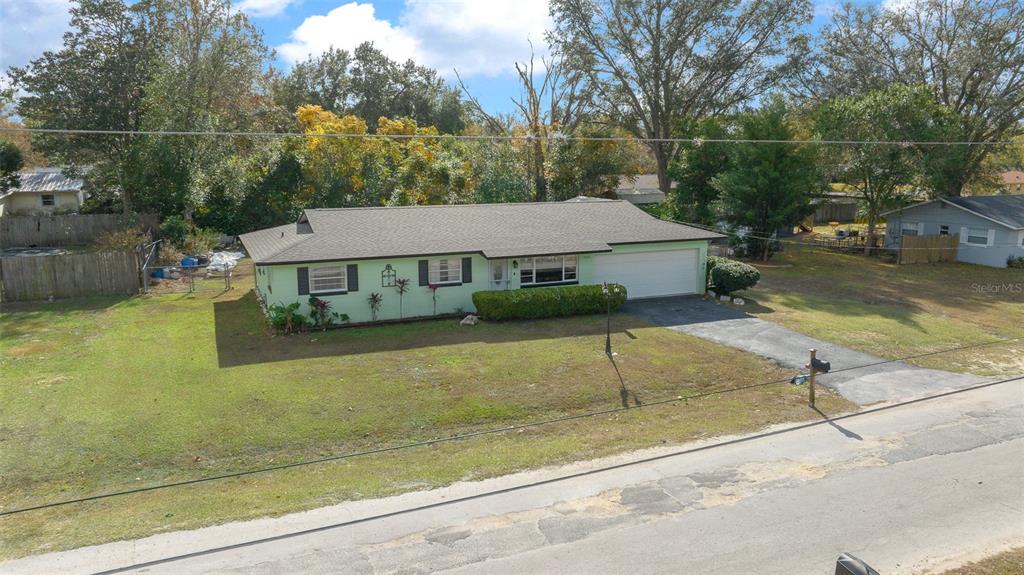 An aerial view of a single-story house with light green siding and a two-car garage — 2004 NE 52ND STREET, OCALA, FL
