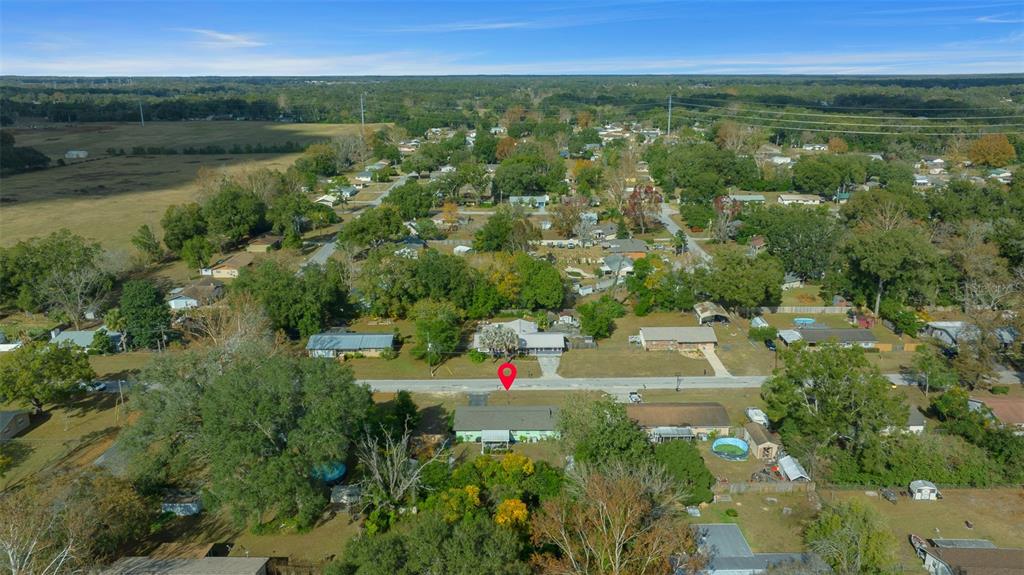 An aerial view shows a single-story house with a red location pin in a neighborhood — 2004 NE 52ND STREET, OCALA, FL
