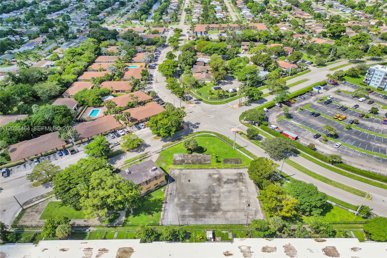 An aerial view shows a residential complex with a parking lot and a basketball court — 2600 NW 60th Ter, Sunrise FL 33313, SUNRISE, FL