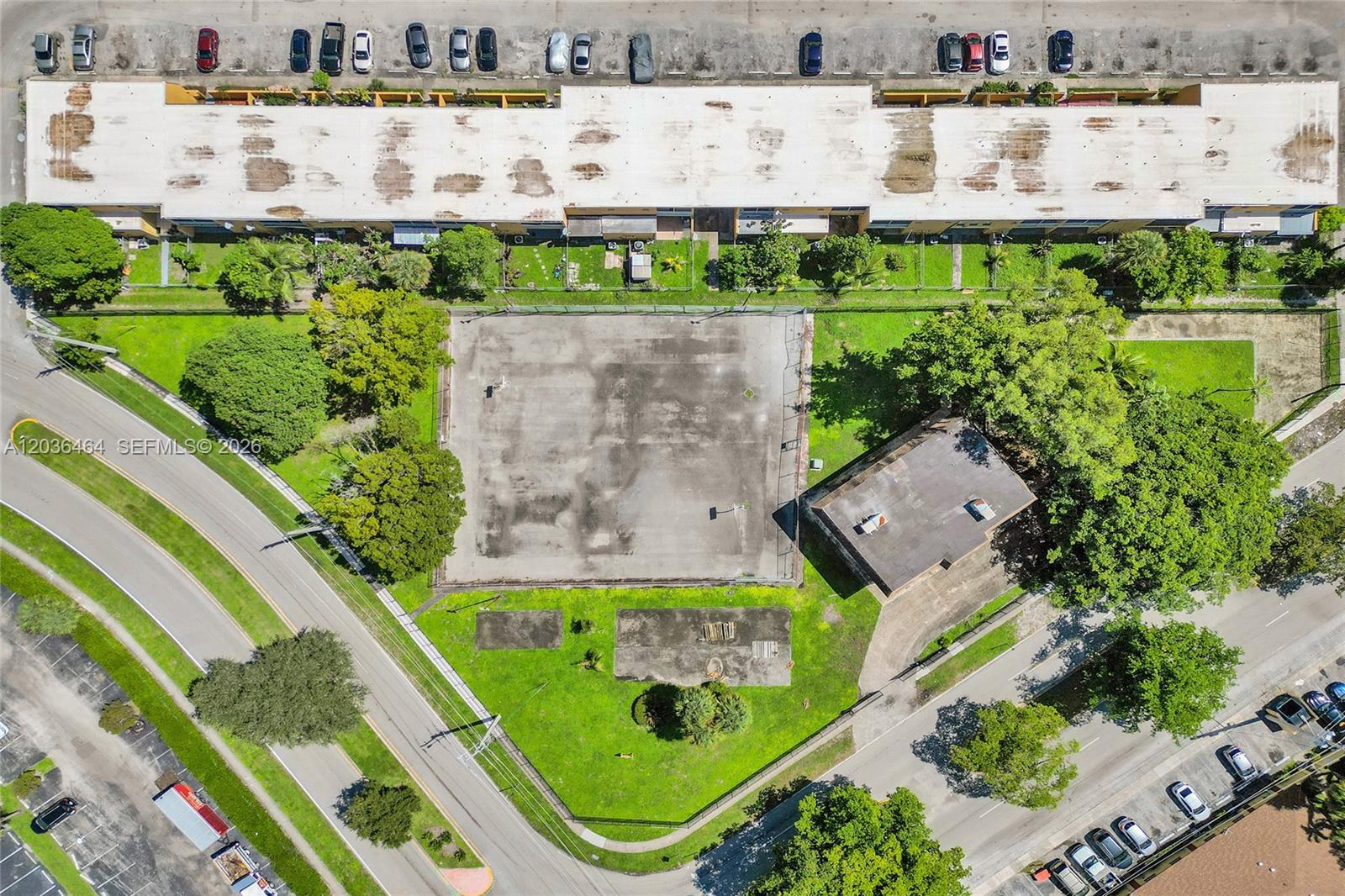 An aerial view shows a basketball court, a small building, and surrounding parking lots — 2600 NW 60th Ter, Sunrise FL 33313, SUNRISE, FL