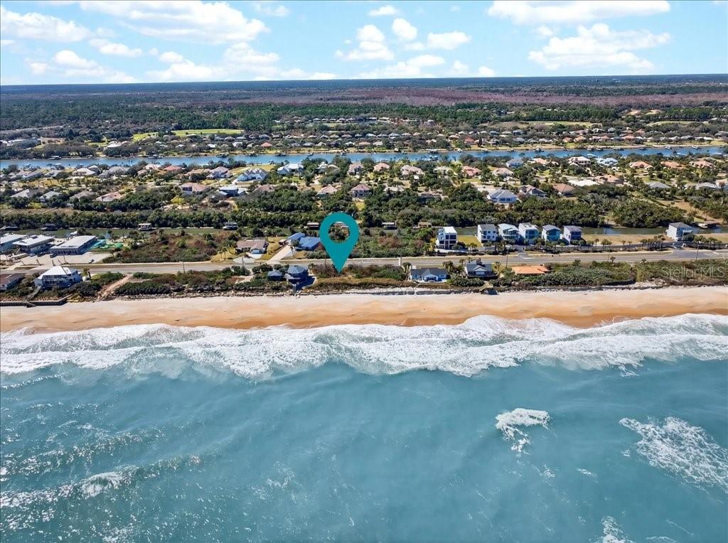 An aerial view shows a vacant beachfront lot marked by a blue location pin — 3527 N OCEAN SHORE BOULEVARD, PALM COAST, FL