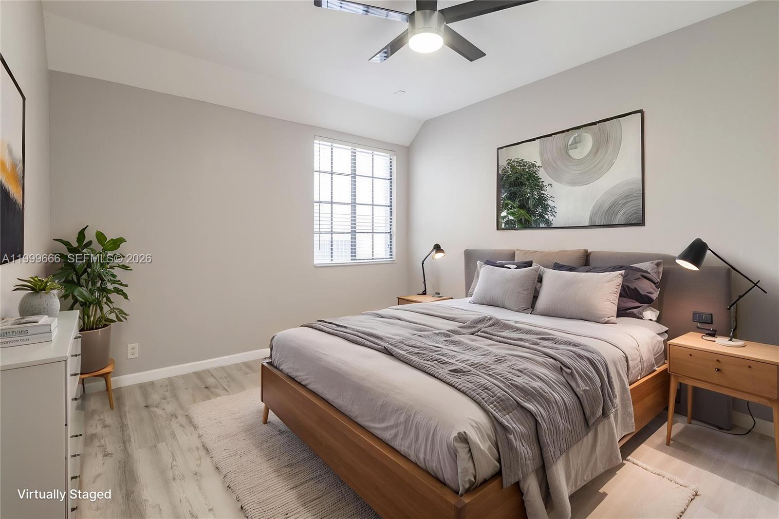 A bedroom features a wooden bed frame, light wood nightstands, and a ceiling fan — 1611 Passion Vine Cir # 2, Weston FL 33326, WESTON, FL