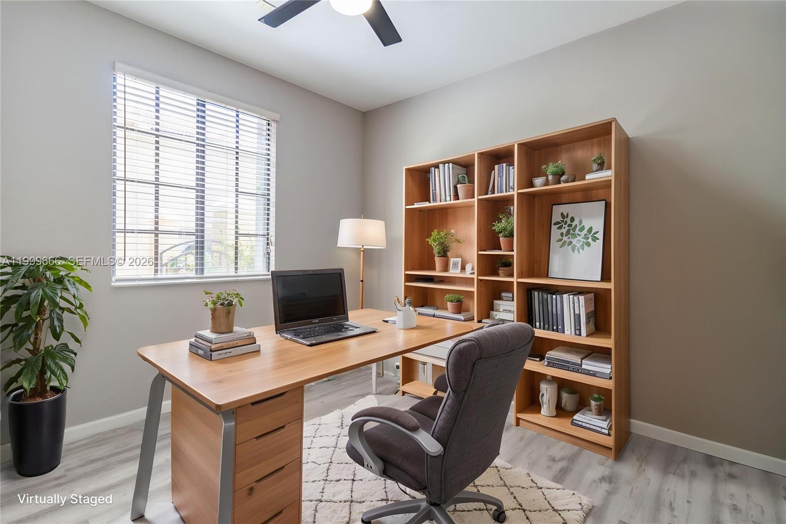 A home office features a wooden desk, a bookshelf, a gray chair, and a window — 1611 Passion Vine Cir # 2, Weston FL 33326, WESTON, FL