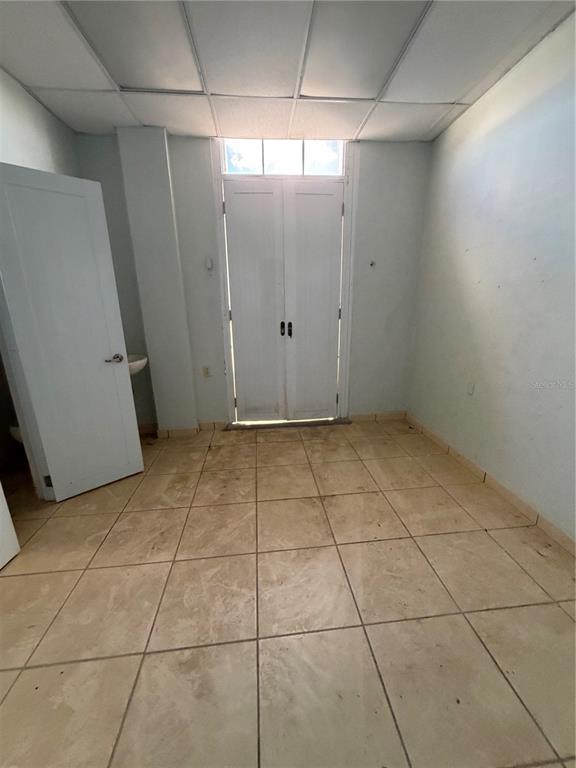 A small room with light-colored tile flooring, a white door, and double glass doors — 179 AVE JOSE DE DIEGO, ARECIBO, PR