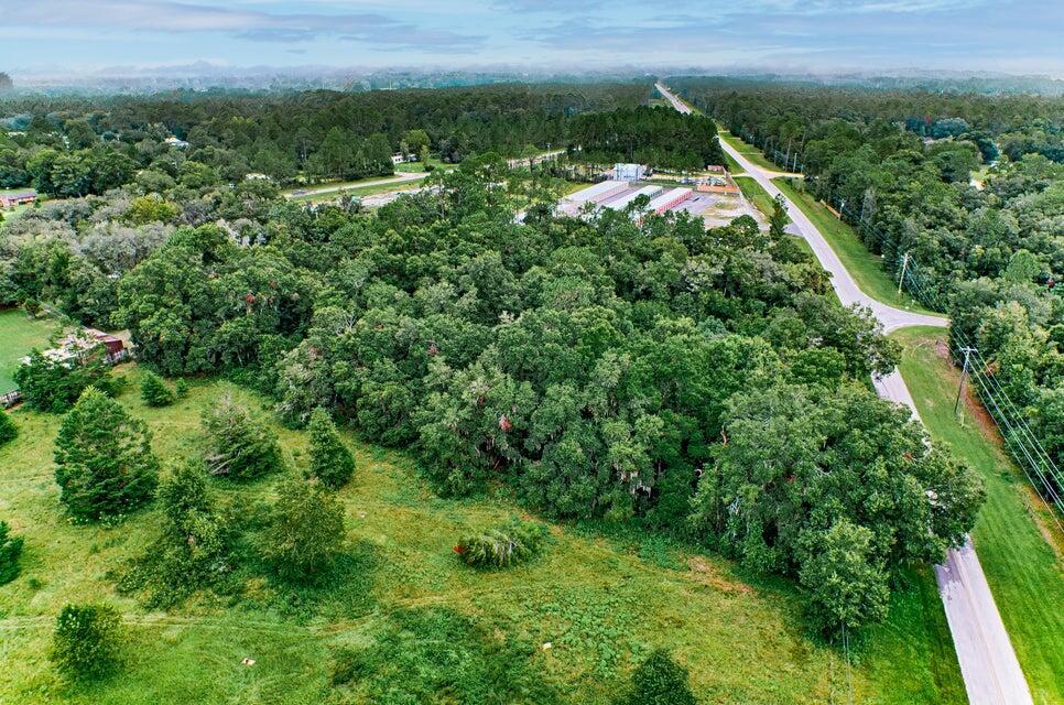 An aerial view shows a large, wooded lot bordered by a road and nearby buildings — 0000 SE 9th Avenue, Starke FL 32091, STARKE, FL