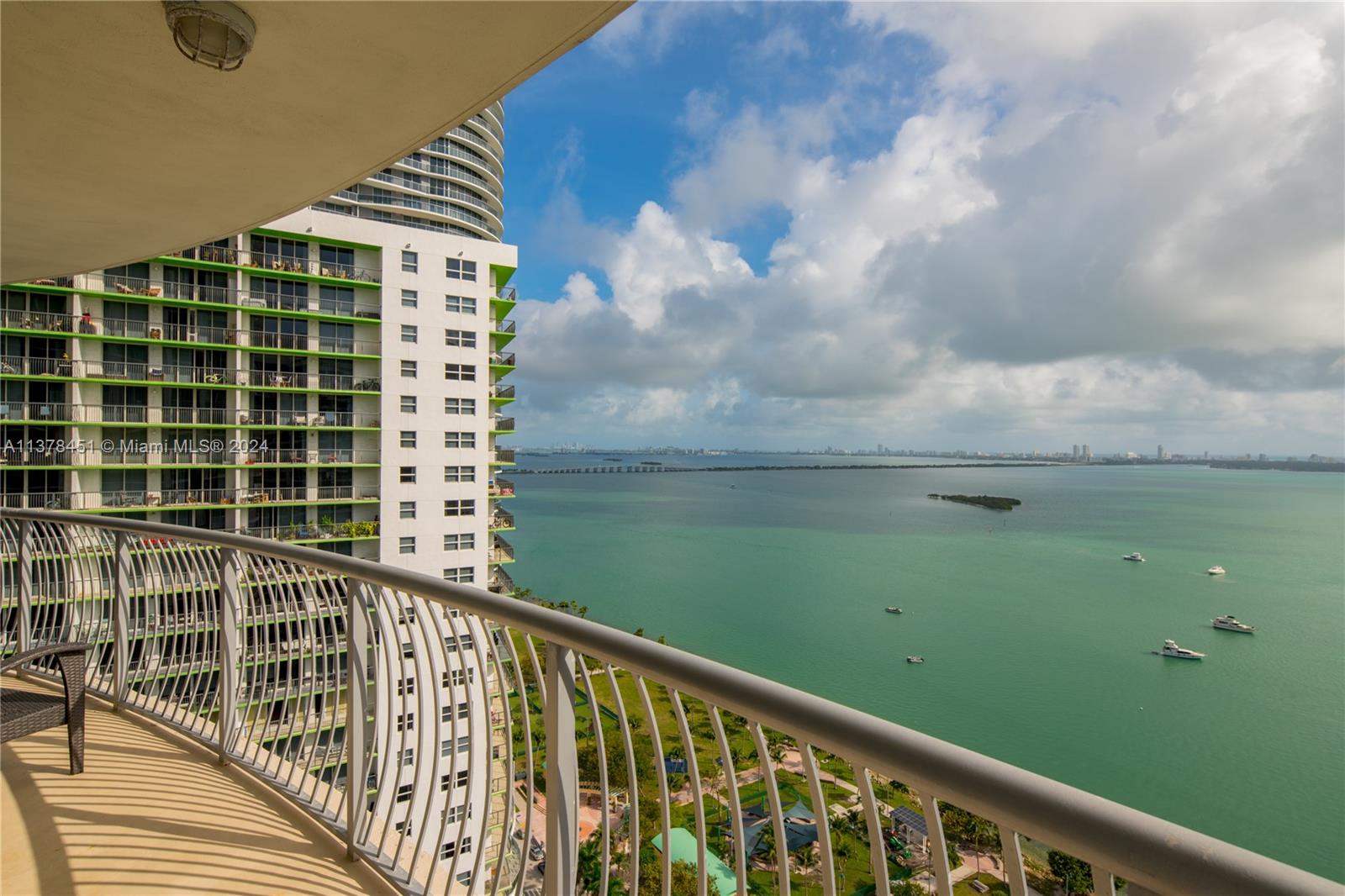 A balcony view overlooking a bay with a high-rise building and boats on the water — 1750 N Bayshore Dr # 3201, Miami FL 33132, MIAMI, FL