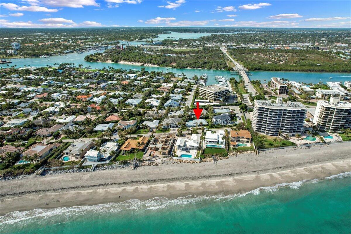 An aerial view shows a coastal neighborhood with a red arrow pointing to a house — 48 Ocean Drive, Jupiter FL 33469, JUPITER, FL